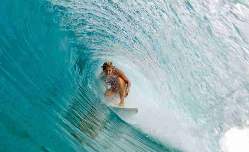 Girl surfing under waves perfect click