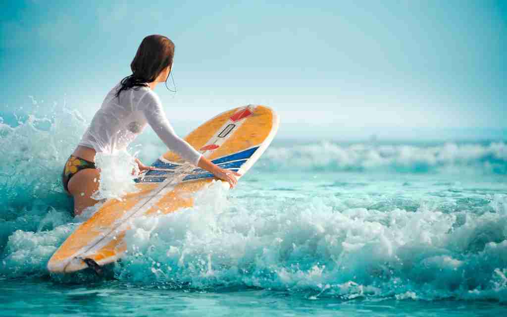 Hot bikini girl surfing ocean
